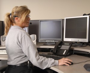 Police dispatcher working at console