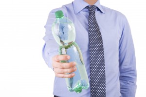Businessman offering a green bottle.